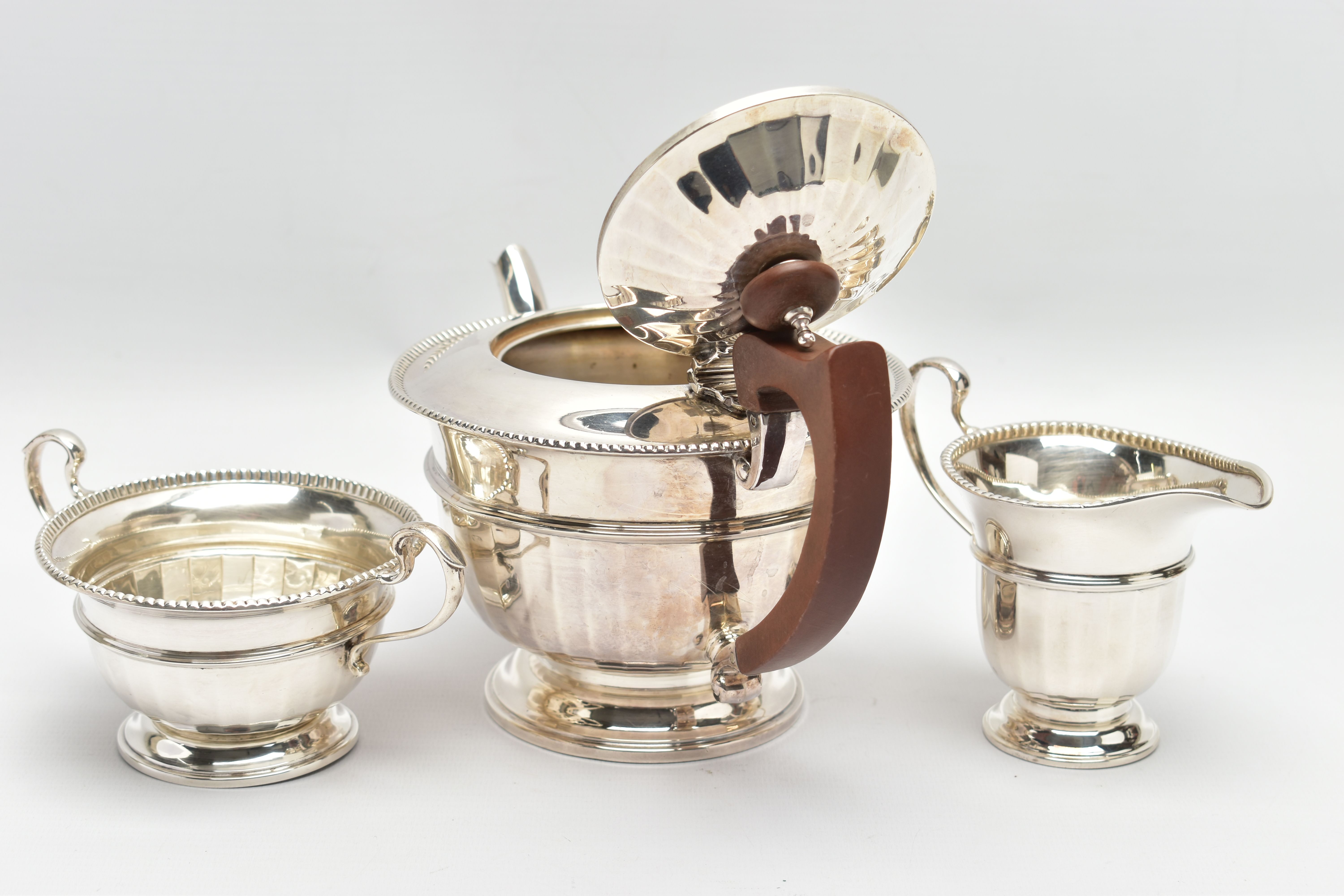 A GEORGE V SILVER THREE PIECE TEA SERVICE OF CIRCULAR PANELLED FORM, reeded rims, S scroll - Image 6 of 9