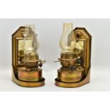 A PAIR OF LATE VICTORIAN BRASS WALL HANGING OIL LAMPS, the shaped rectangular raised back fitted