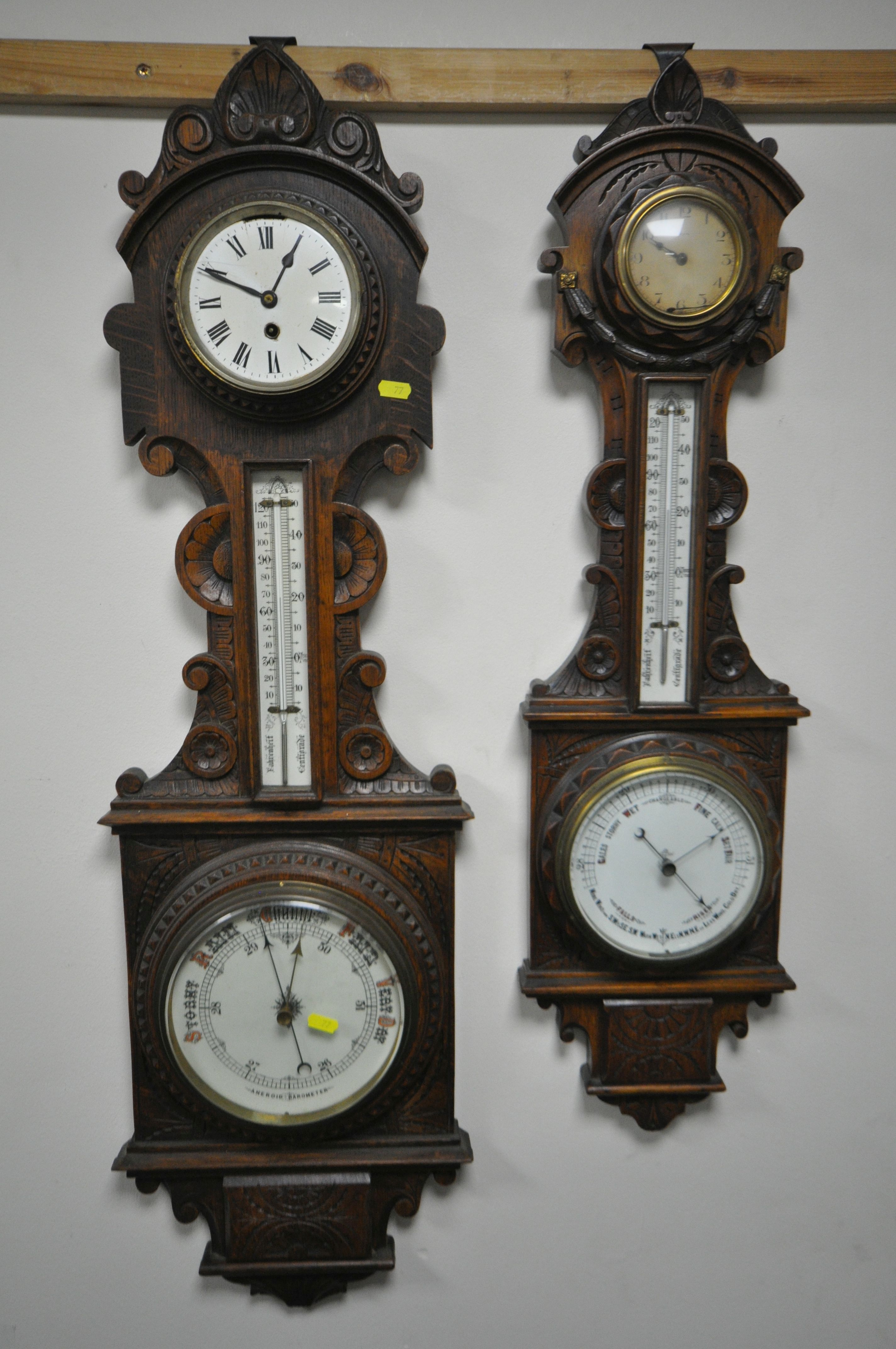 TWO LATE 19TH/EARLY 20TH CENTURY CARVED OAK ANEROID BAROMETERS, with clock dials and thermometers,