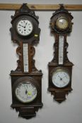 TWO LATE 19TH/EARLY 20TH CENTURY CARVED OAK ANEROID BAROMETERS, with clock dials and thermometers,