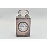 AN EDWARDIAN WILLIAM COMYNS MINIATURE SILVER BOUDOIR CLOCK, the plain case with swing carrying