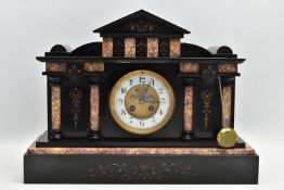 A LATE VICTORIAN BLACK SLATE AND MARBLE INSET MANTEL CLOCK OF ARCHITECTURAL FORM, the case with gilt