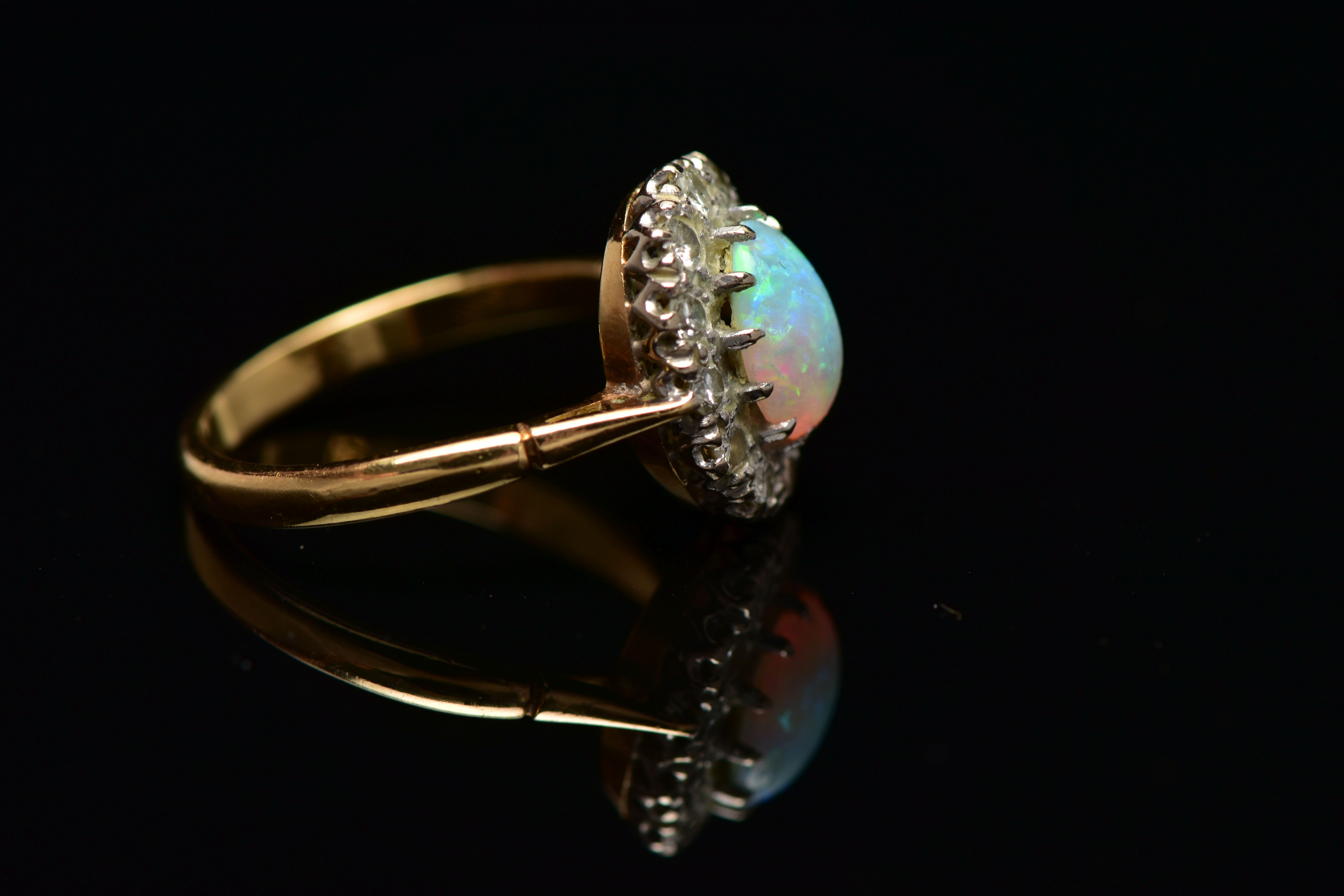 AN OPAL AND DIAMOND CLUSTER RING, set with an oval opal cabochon, measuring approximately 8.2mm x - Image 10 of 10