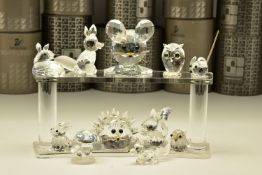 ELEVEN BOXED SWAROVSKI CRYSTAL ORNAMENTS, from various collections, comprising five from Woodland