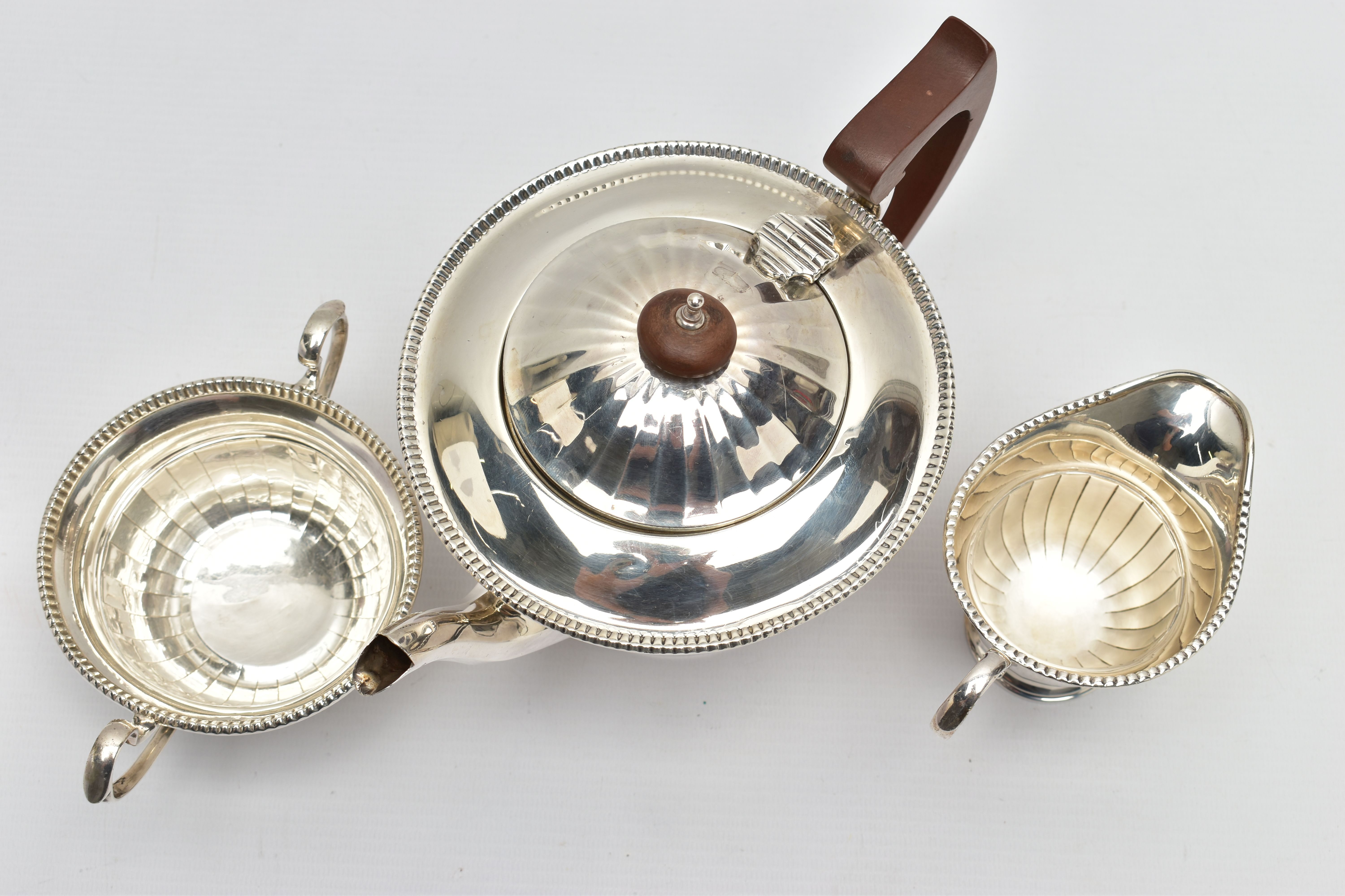 A GEORGE V SILVER THREE PIECE TEA SERVICE OF CIRCULAR PANELLED FORM, reeded rims, S scroll - Image 8 of 9