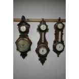 THREE LATE 19TH/EARLY 20TH CENTURY CARVED WOOD BAROMETERS, with clock dials, and two with