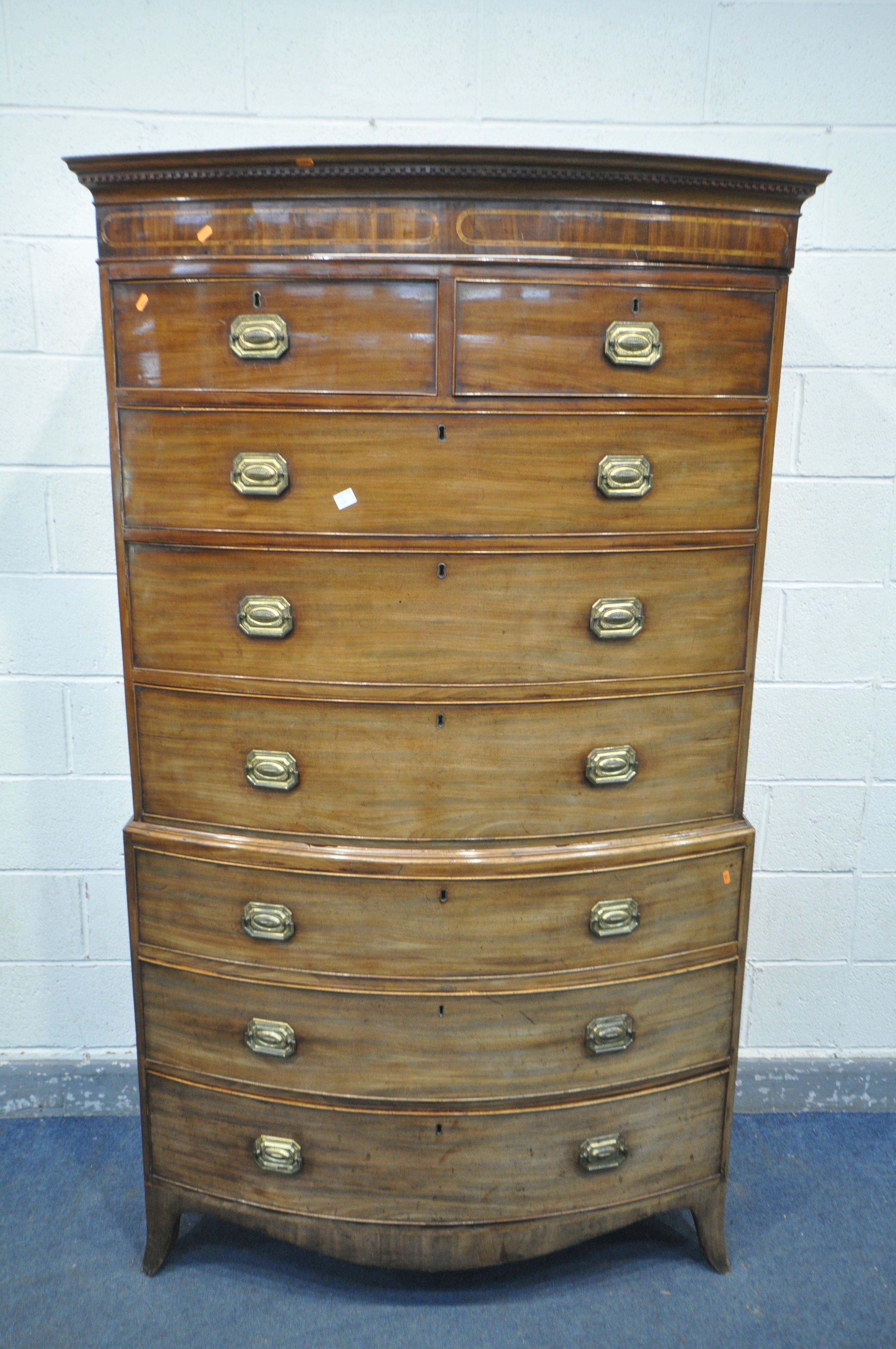 A GEORGE IV WALNUT BOWFRONT CHEST ON CHEST, of two short over six long graduated drawers, brass