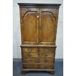 A GEORGIAN WALNUT CUPBOARD, the double fielded panel doors, enclosing a converted interior, with two