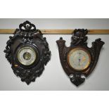 A 20TH CENTURY BLACK FOREST STYLE ANEROID BAROMETER, the frame having a ribbon surmount, foliage,