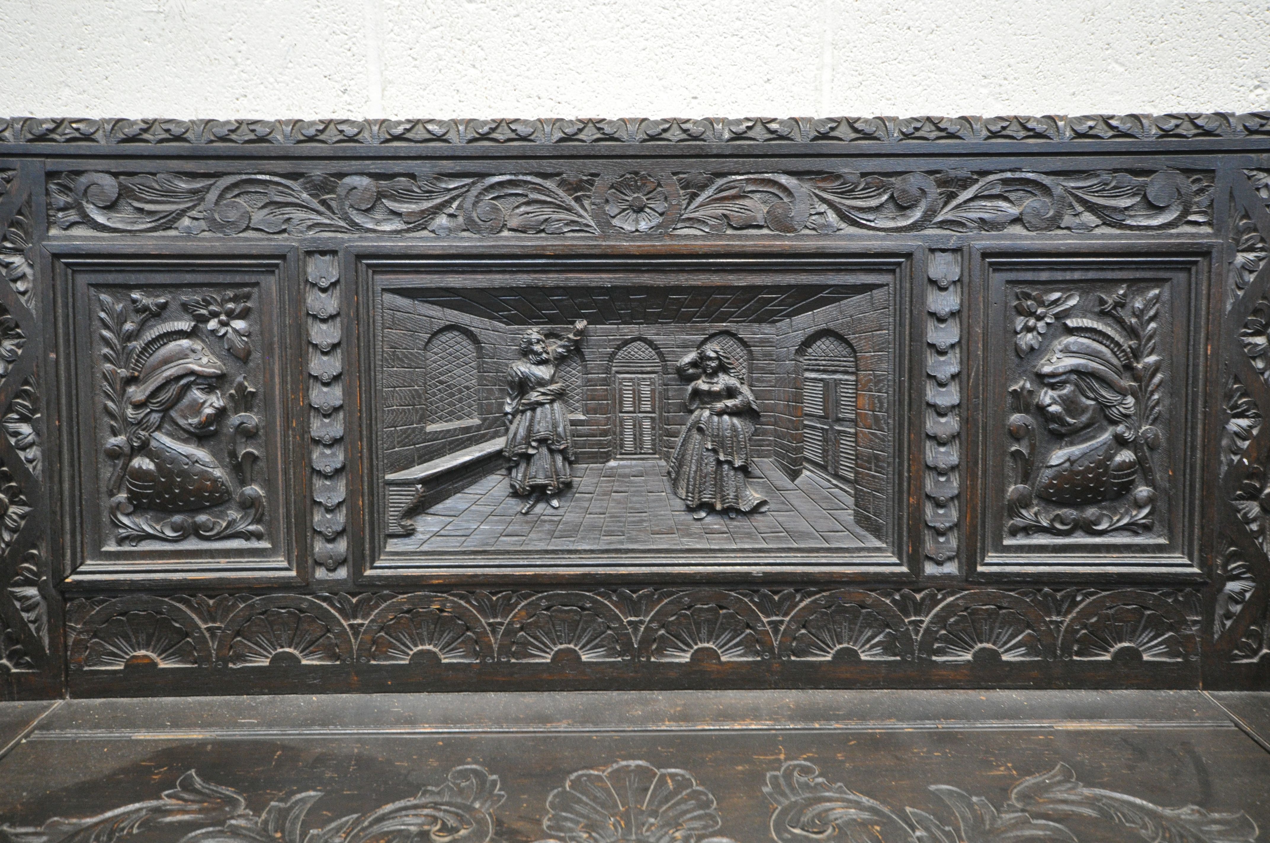 A LATE 19TH CENTURY CARVED OAK JACOBETHAN STYLE HALL SETTLE/BENCH, the two outer panels depicting - Image 4 of 9