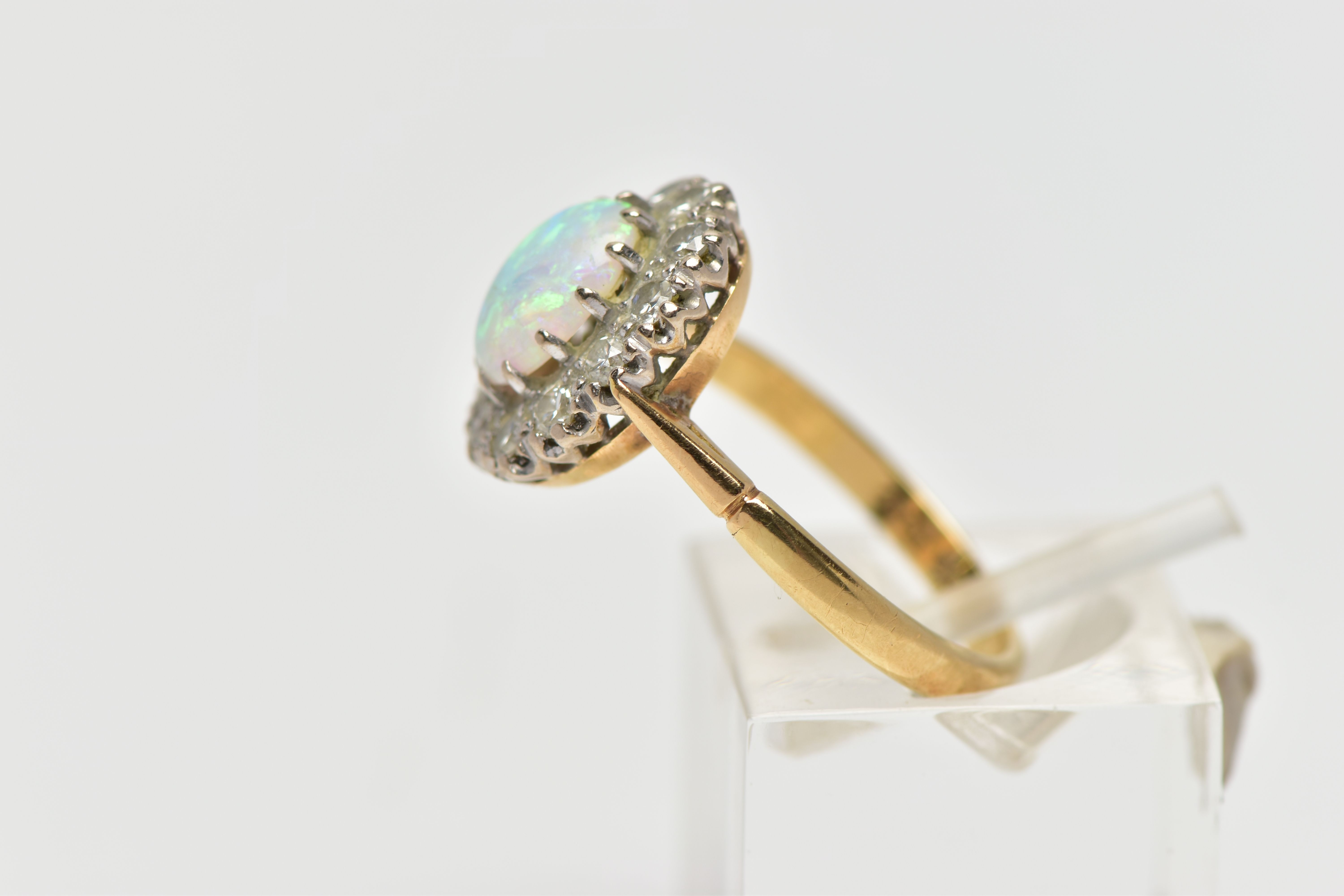 AN OPAL AND DIAMOND CLUSTER RING, set with an oval opal cabochon, measuring approximately 8.2mm x - Image 2 of 10