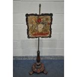 A VICTORIAN WALNUT POLE SCREEN, the shaped frame with a glass panel enclosing a needlework