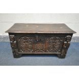 A 17TH CENTURY OAK COFFER, made up of six planks, the carved front with depicting two standing males