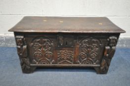 A 17TH CENTURY OAK COFFER, made up of six planks, the carved front with depicting two standing males