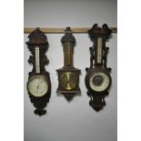 THREE LATE 19TH/EARLY 20TH CENTURY OAK ANEROID BAROMETERS, each signed separately by Dolland of