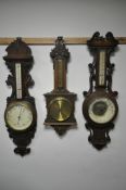 THREE LATE 19TH/EARLY 20TH CENTURY OAK ANEROID BAROMETERS, each signed separately by Dolland of