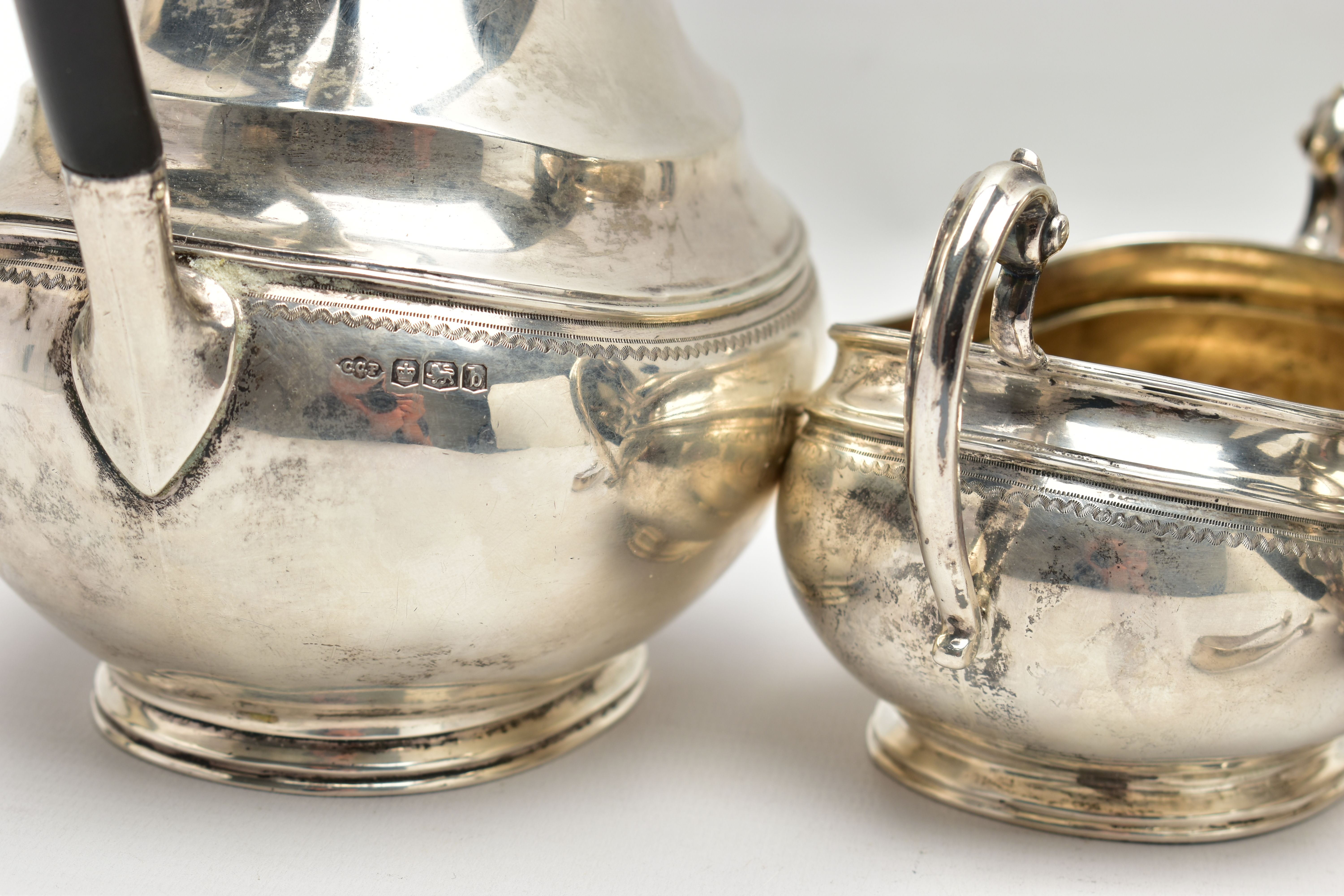 A GEORGE V SILVER FOUR PIECE TEA SERVICE OF OVAL FORM, comprising tea pot, hot water/coffee jug, - Image 8 of 9