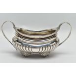 A GEORGE III SILVER TWIN HANDLED SUGAR BOWL OF OVAL FORM, gadrooned rim, cornucopia cast C scroll