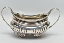 A GEORGE III SILVER TWIN HANDLED SUGAR BOWL OF OVAL FORM, gadrooned rim, cornucopia cast C scroll