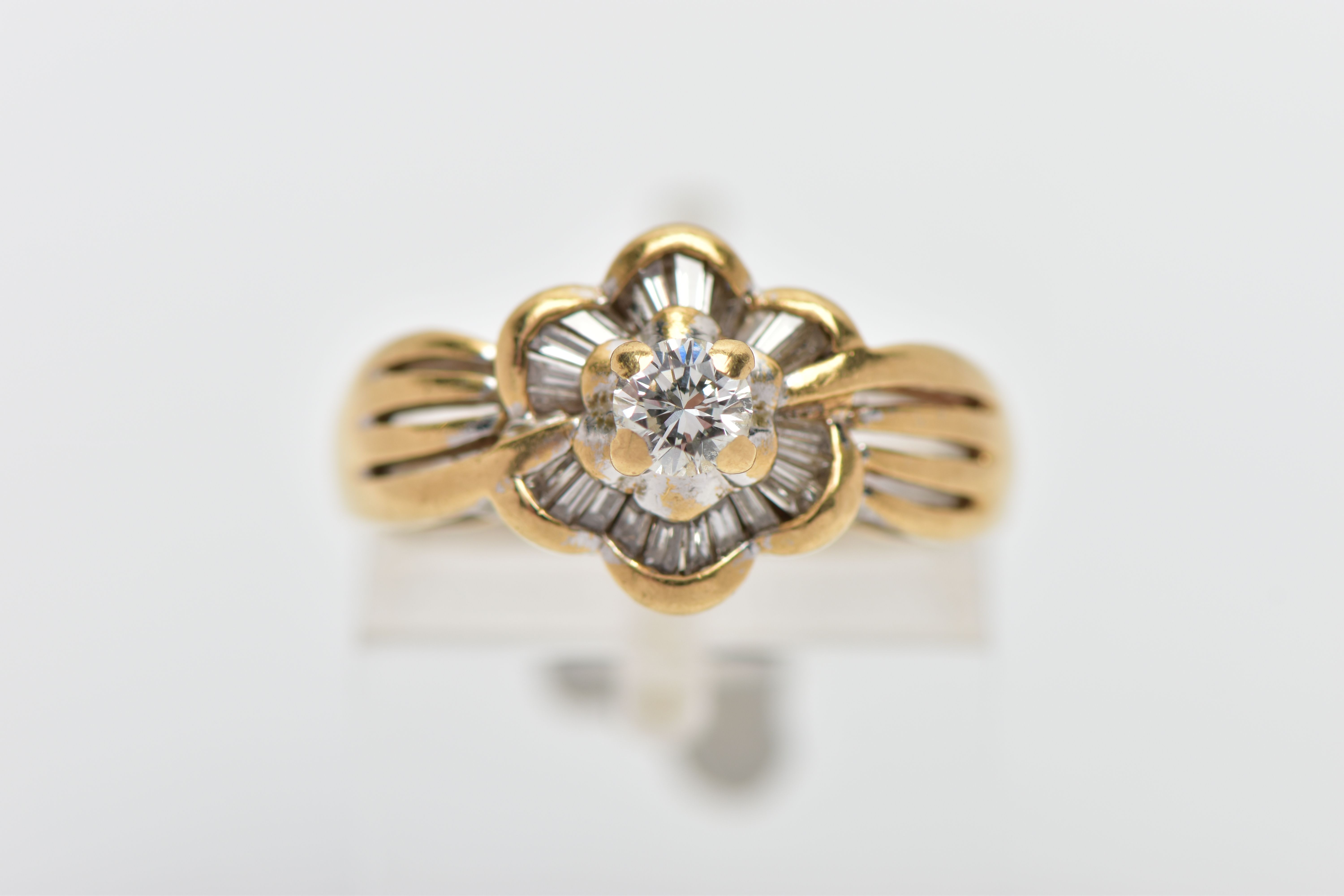 A MODERN YELLOW METAL DIAMOND CLUSTER RING, set with a principal round brilliant cut diamond, within - Image 5 of 8