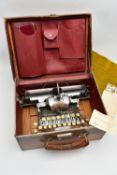 AN EARLY 20TH CENTURY BLICK ALUMINIUM FEATHERWEIGHT TYPEWRITER IN A TAN LEATHER COVERED CASE, the