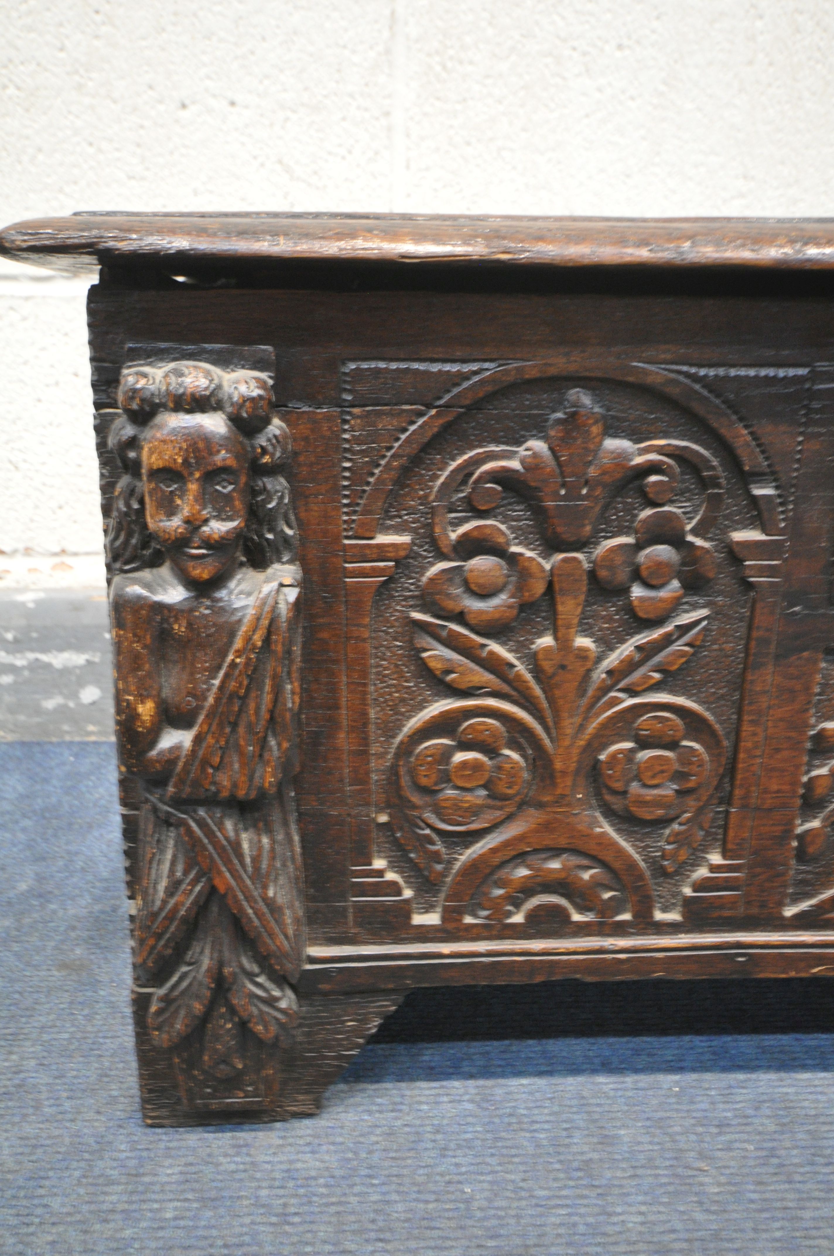 A 17TH CENTURY OAK COFFER, made up of six planks, the carved front with depicting two standing males - Image 3 of 9