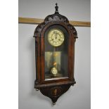 A 19TH CENTURY CONTINENTAL WALNUT WALL CLOCK, having a domed top and door, enclosing a dial with