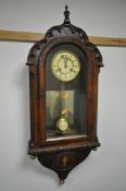 A 19TH CENTURY CONTINENTAL WALNUT WALL CLOCK, having a domed top and door, enclosing a dial with