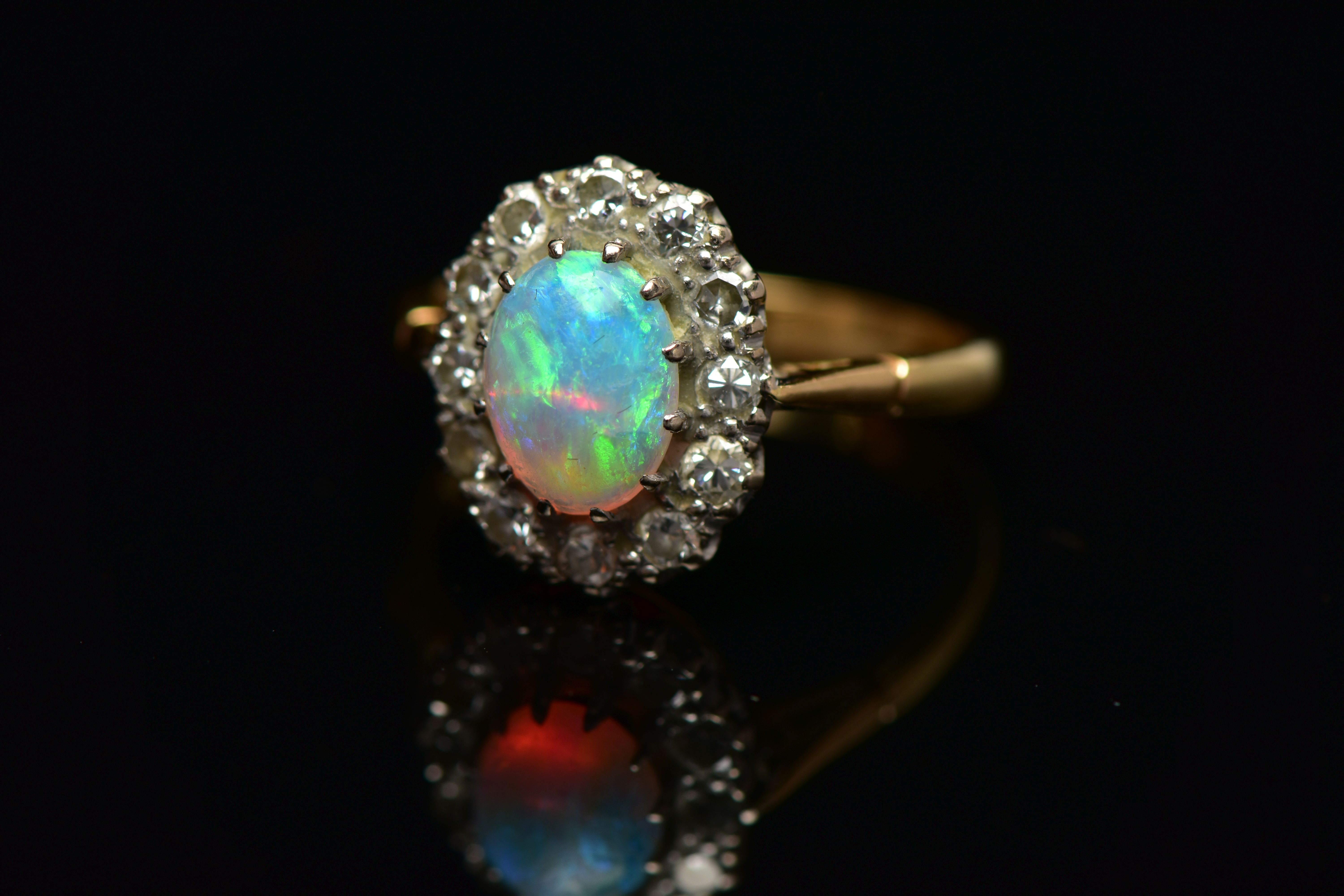 AN OPAL AND DIAMOND CLUSTER RING, set with an oval opal cabochon, measuring approximately 8.2mm x - Image 9 of 10