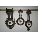 A LATE 19TH CENTURY FRENCH CARVED WALNUT ANEROID BAROMETER, height 90cm and an oak aneroid