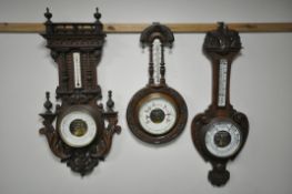 A LATE 19TH CENTURY FRENCH CARVED WALNUT ANEROID BAROMETER, height 90cm and an oak aneroid