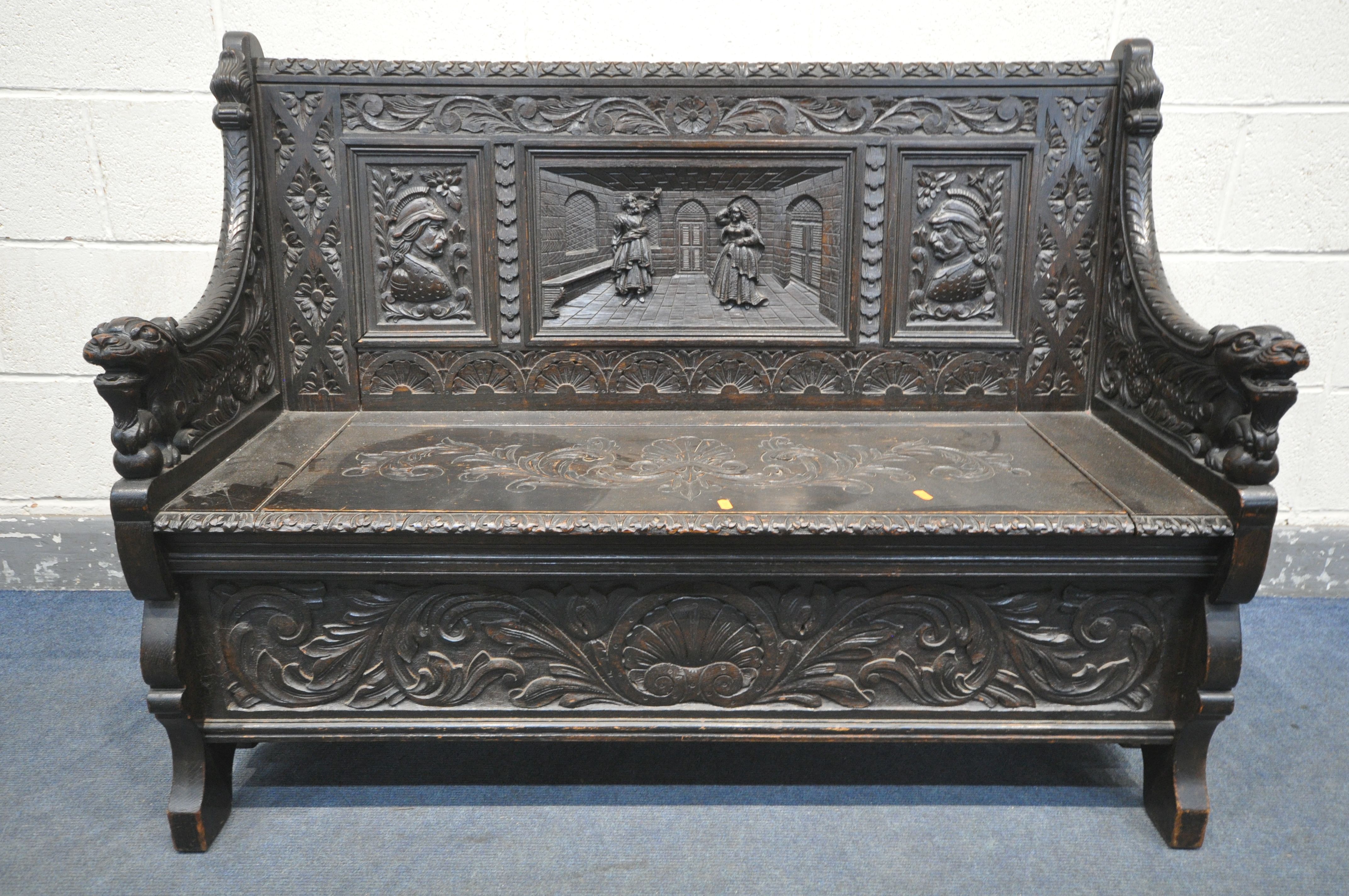 A LATE 19TH CENTURY CARVED OAK JACOBETHAN STYLE HALL SETTLE/BENCH, the two outer panels depicting