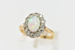 AN OPAL AND DIAMOND CLUSTER RING, set with an oval opal cabochon, measuring approximately 8.2mm x