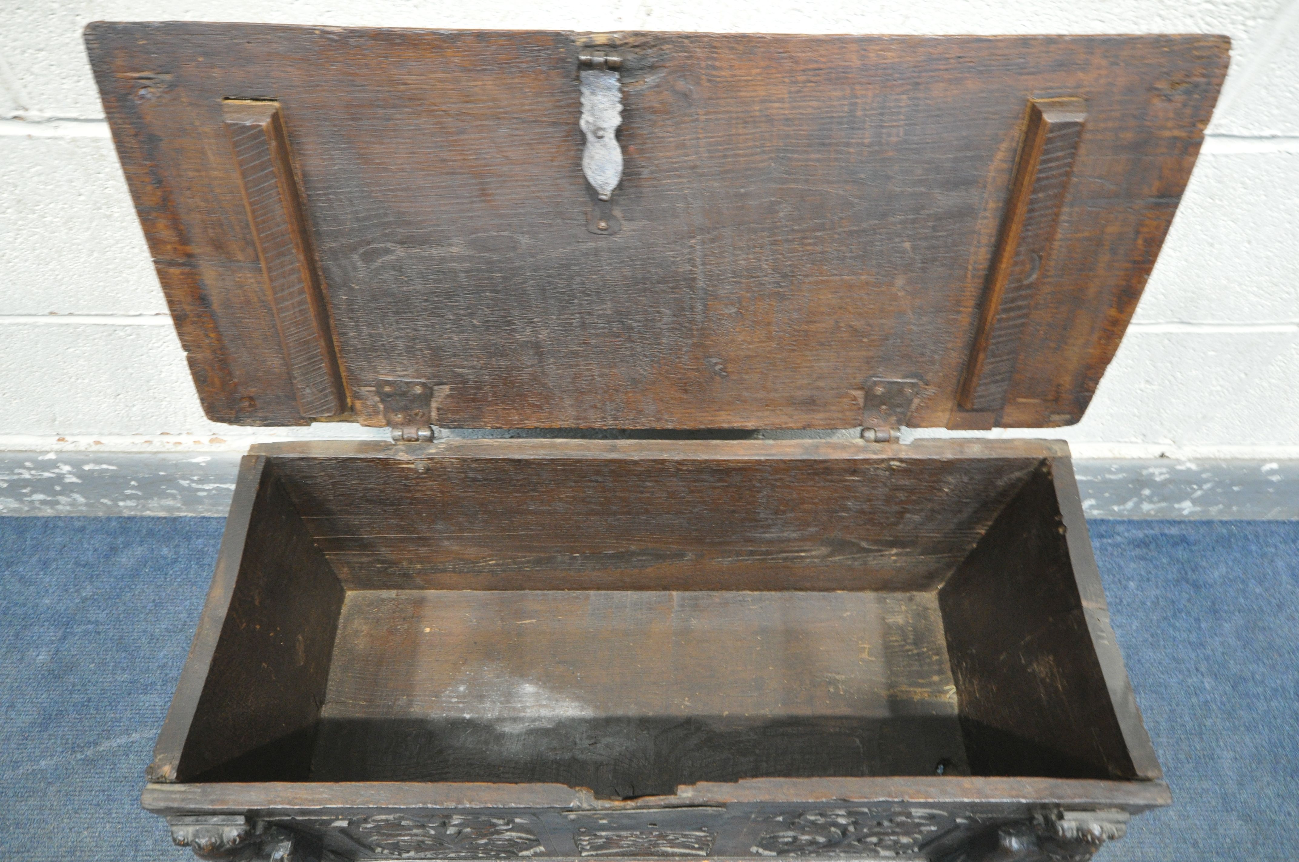 A 17TH CENTURY OAK COFFER, made up of six planks, the carved front with depicting two standing males - Image 5 of 9