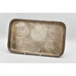 AN EARLY 20TH CENTURY SILVER RECTANGULAR TRAY, gadrooned rim, marks totally illegible due to