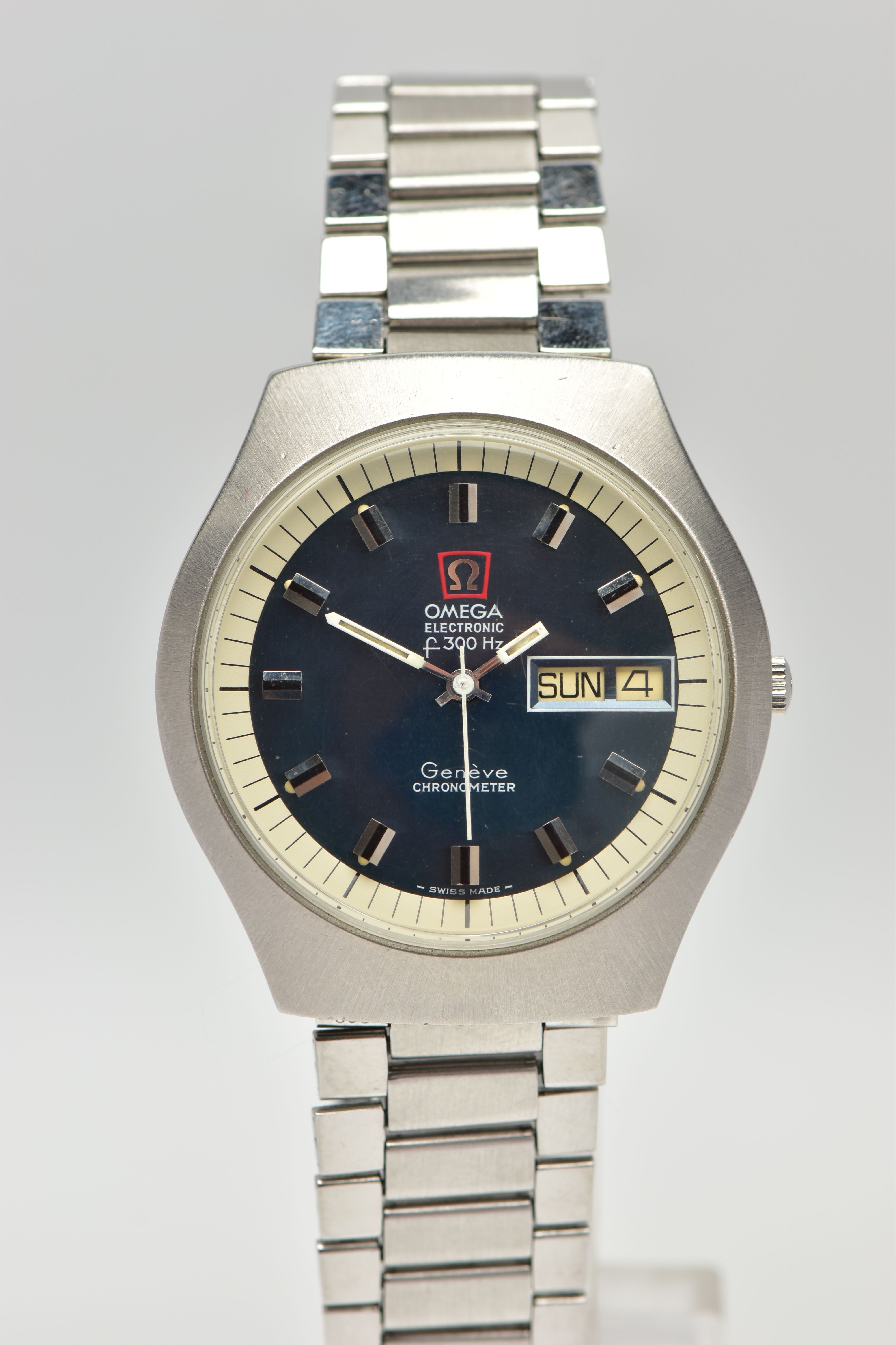 A VINTAGE STAINLESS STEEL DAY-DATE F300HZ OMEGA WRISTWATCH, the dark blue dial, with black and
