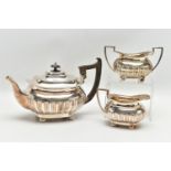 AN EDWARDIAN WALKER & HALL THREE PIECE SILVER TEA SERVICE OF SHAPED RECTANGULAR FORM, the tea pot