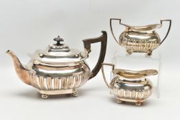 AN EDWARDIAN WALKER & HALL THREE PIECE SILVER TEA SERVICE OF SHAPED RECTANGULAR FORM, the tea pot