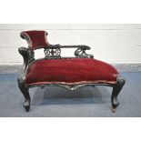 A 19TH CENTURY EBONISED CARVED WOOD SERPENTINE CHAISE LONGUE, of small proportions, having a