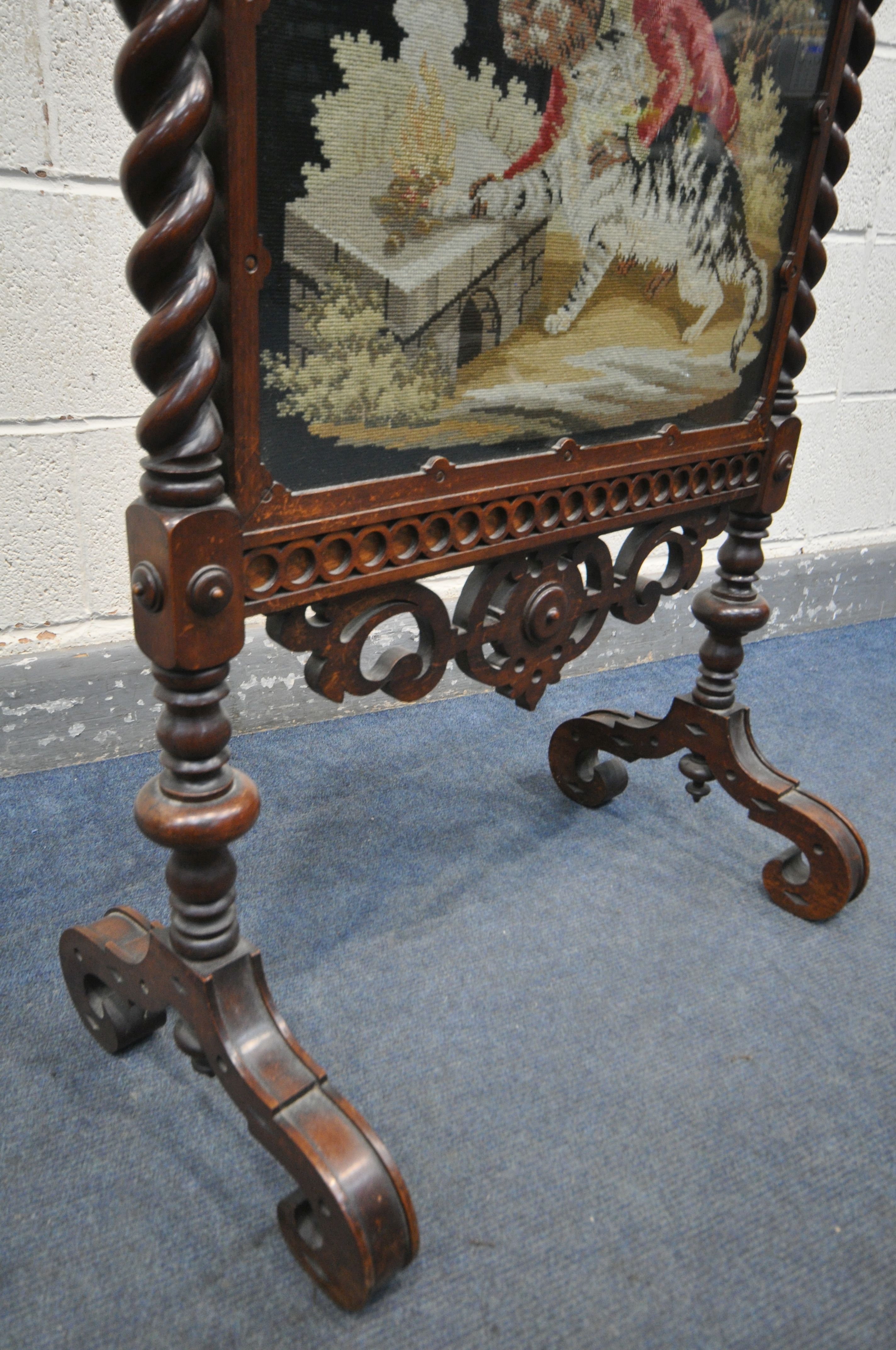 A VICTORIAN WALNUT FIRESCREEN, with open scrolls and central shield, turned finials, barley twist - Image 4 of 5