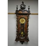 A LATE 19TH CENTURY VIENNA WALL CLOCK, with a resin horse pediment, turned pillars to the doors,