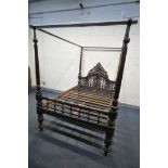 AN 18TH CENTURY OAK AND MAHOGANY 4FT6 FOUR POSTER BED, having a foliate open fretwork headboard,