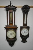 AN EARLY 20TH CENTURY CARVED OAK BAROMETER, with mercury door and thermometer, unsigned, height