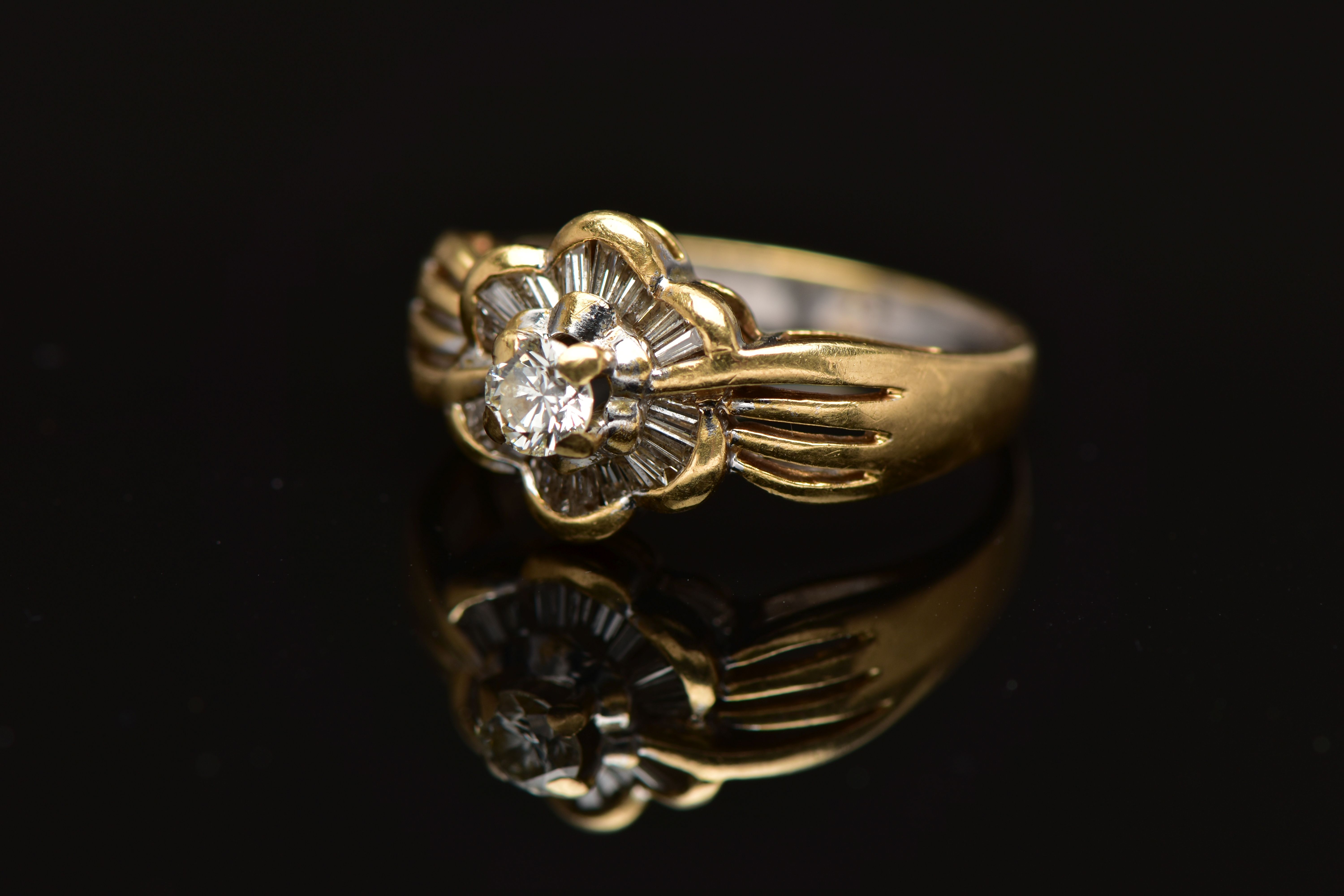 A MODERN YELLOW METAL DIAMOND CLUSTER RING, set with a principal round brilliant cut diamond, within - Image 7 of 8