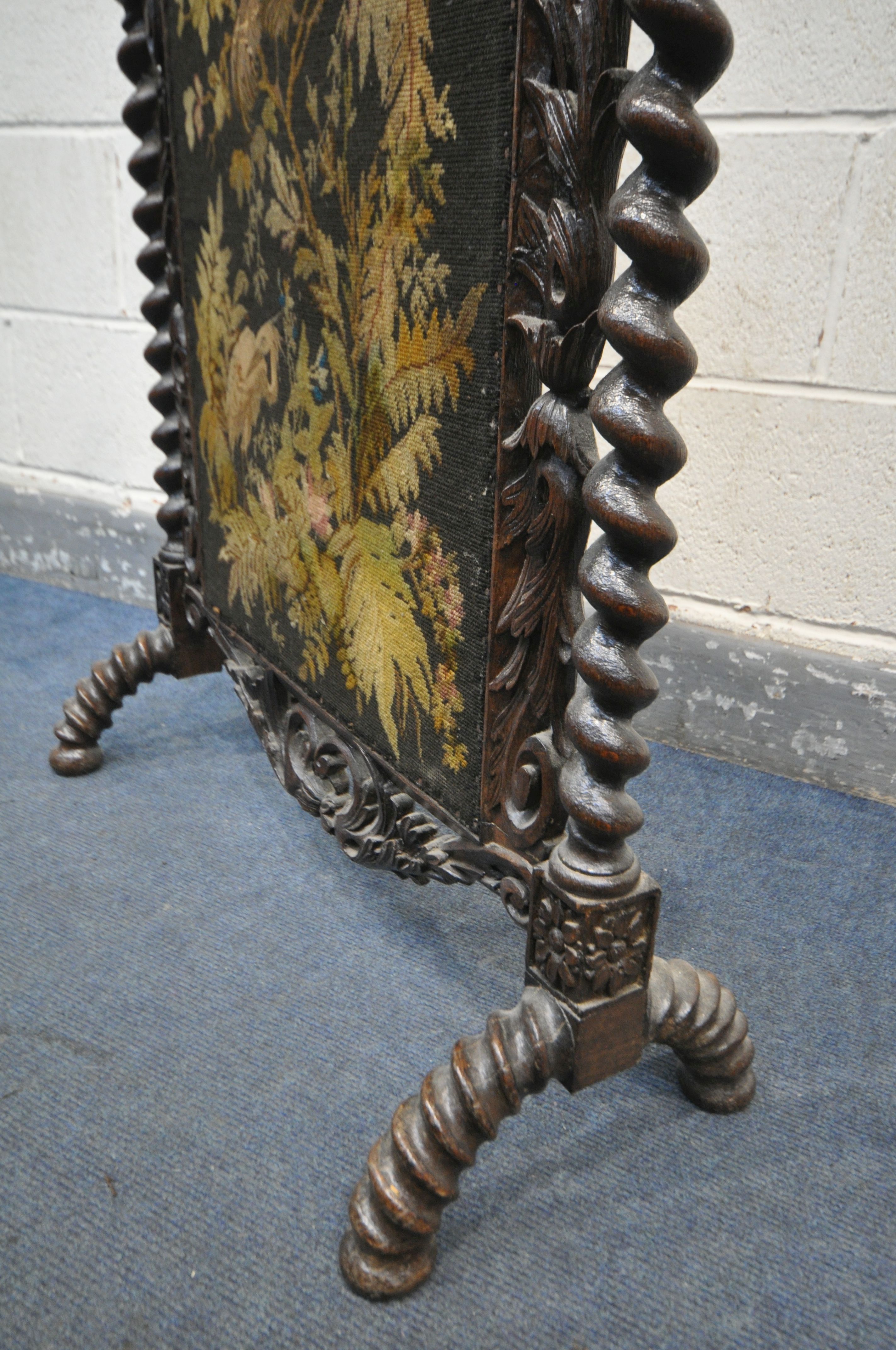 A VICTORIAN CARVED OAK FIRESCREEN, the detailed foliate decorated frame, central lettering reading - Image 4 of 6