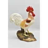 A ROYAL CROWN DERBY BONE CHINA FIGURE OF A COCKEREL STANDING ON A LOG, polychrome decoration,