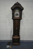 A 20TH CENTURY OAK EIGHT DAY LONGCASE CLOCK, within a heavily carved case with a peacock to