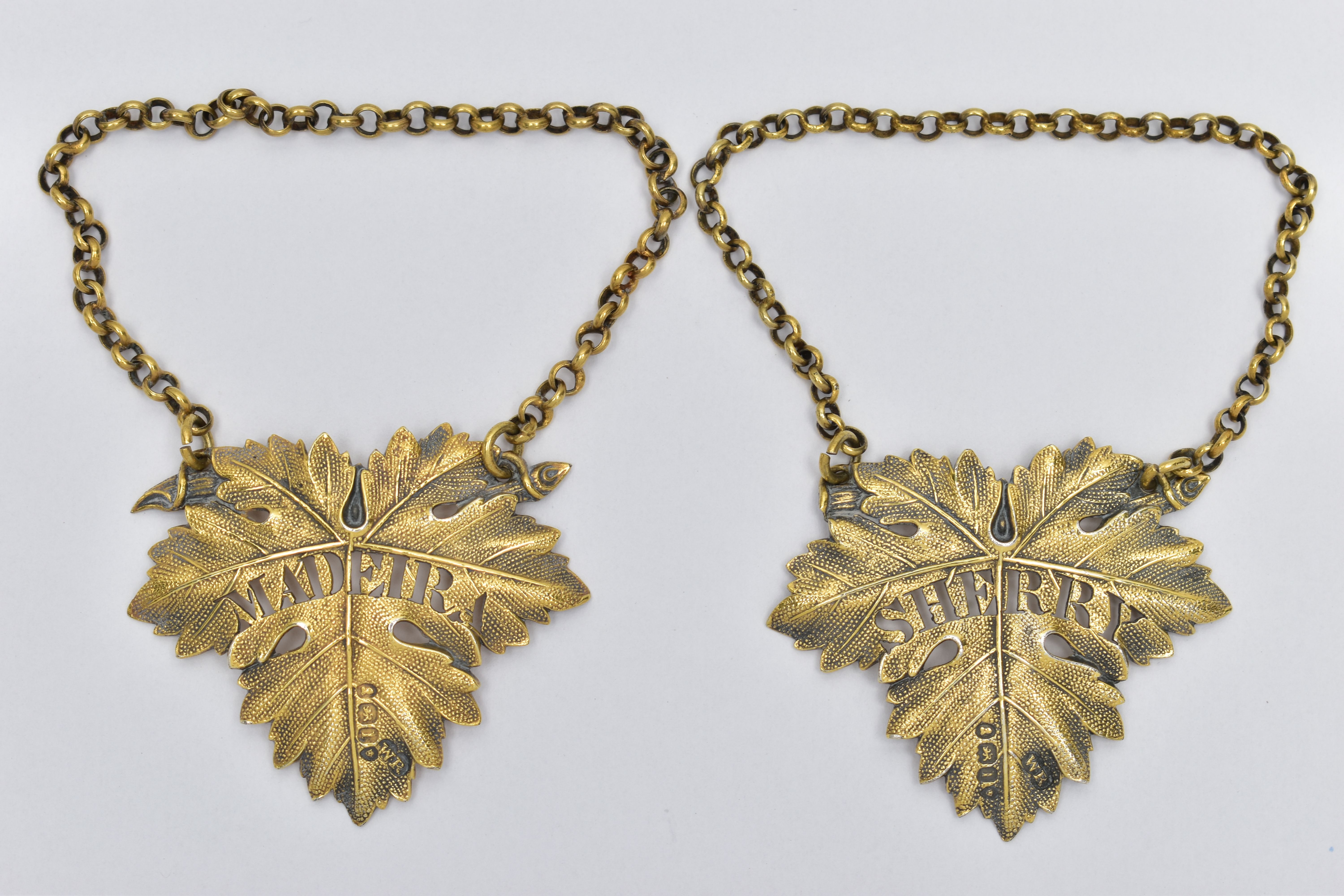 A PAIR OF GEORGE IV SILVER GILT DECANTER LABELS, cast as vine leaves, named for 'SHERRY' and '