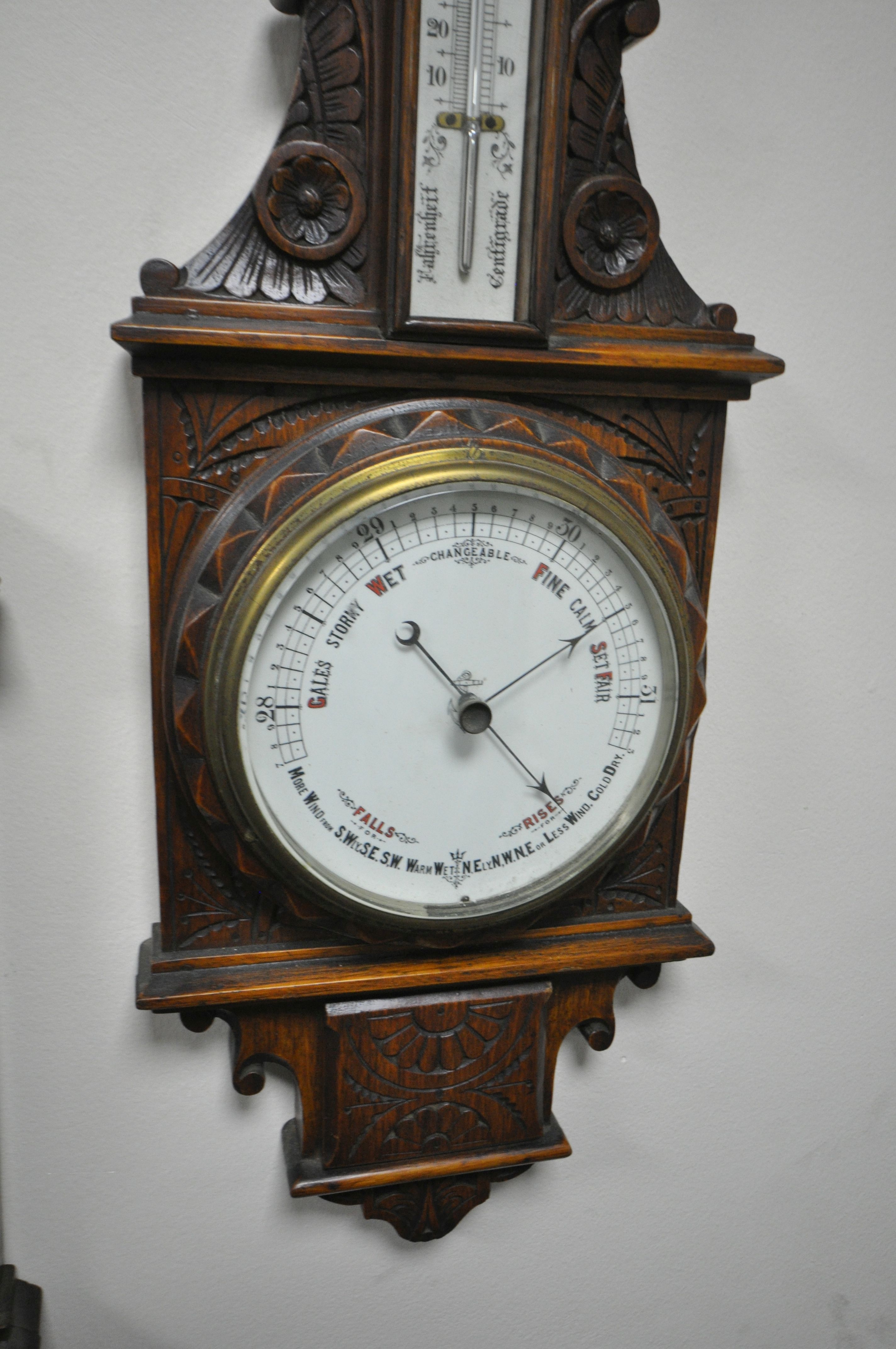 TWO LATE 19TH/EARLY 20TH CENTURY CARVED OAK ANEROID BAROMETERS, with clock dials and thermometers, - Image 5 of 5