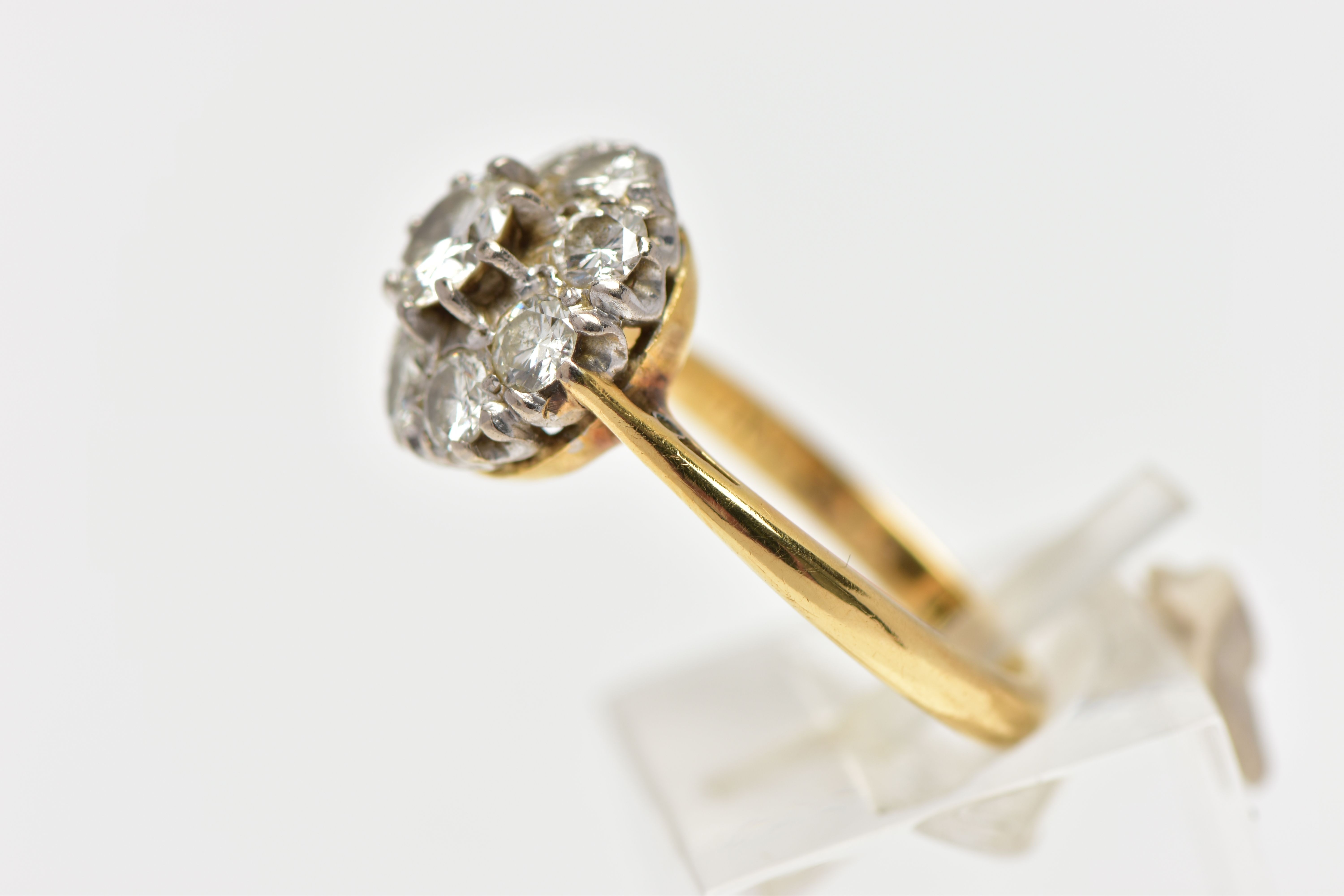 A DIAMOND NINE STONE CLUSTER RING, set with a principal round brilliant cut diamond, surrounded by - Image 2 of 9